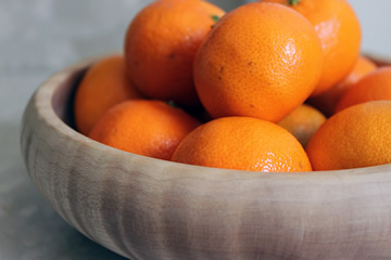 Poplar wooden bowl with oranges.